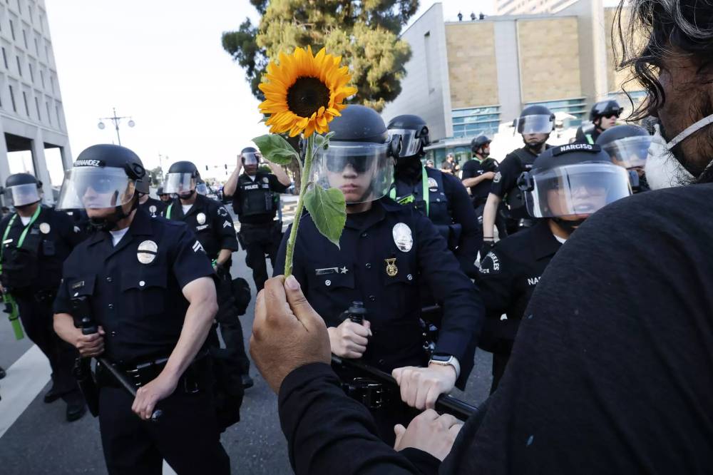 Carlin Stiehl/Los Angeles Times/TNS
Los Angeles police officers push anti-ICE protesters down Los Angeles Street, away from the Federal Building, on June 9.