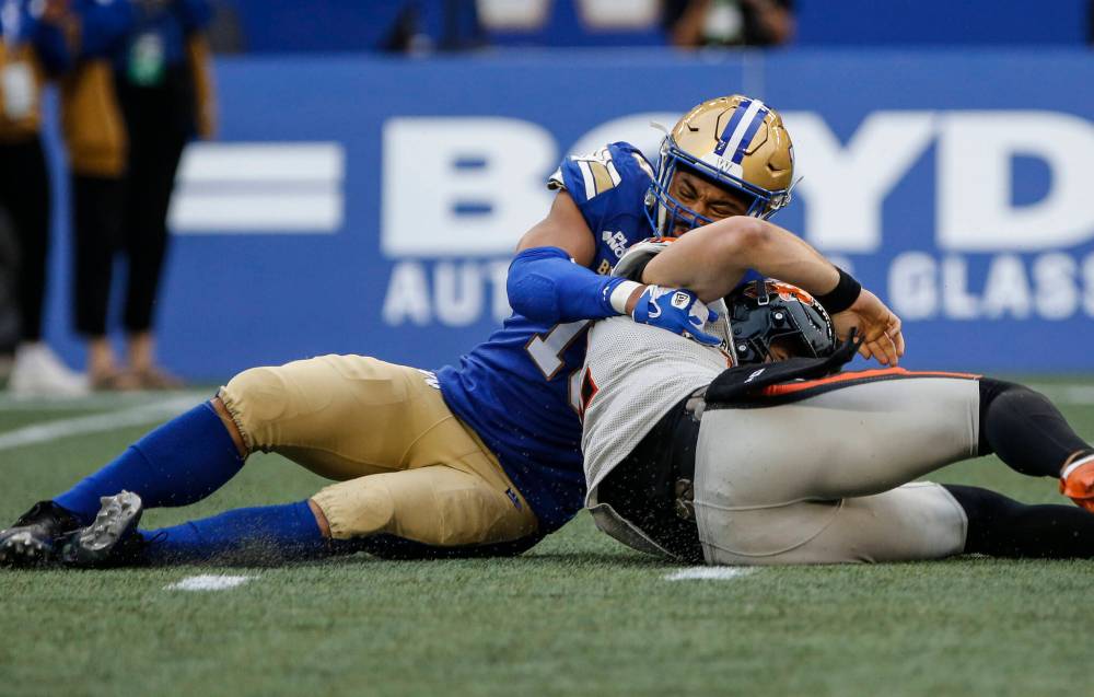 John Woods / THE CANADIAN PRESS
Winnipeg Blue Bombers’ Kyrie Wilson (19) sacks B.C. Lions quarterback Nathan Rourke (12) in the first half.