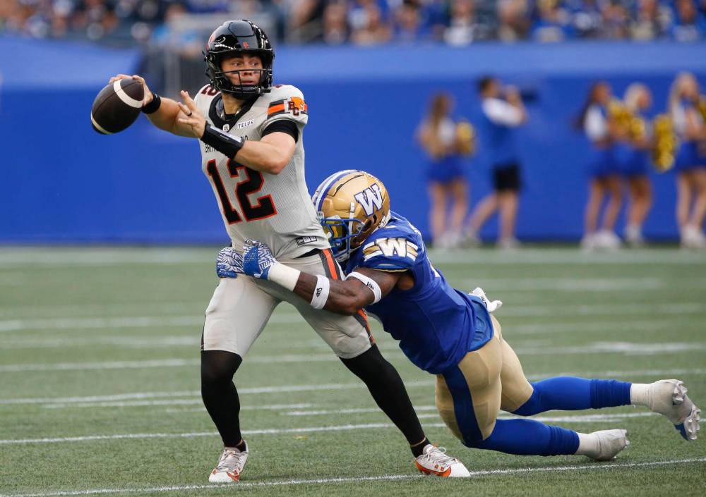 John Woods / THE CANADIAN PRESS
B.C. Lions quarterback Nathan Rourke gets wrapped up by Winnipeg Blue Bombers’ Willie Jefferson in the first half.