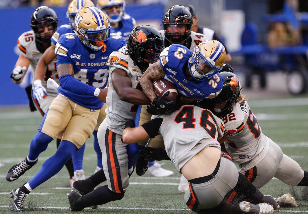John Woods / THE CANADIAN PRESS
Winnipeg Blue Bombers’ Trey Vaval (23) runs for the first down against the B.C. Lions in the first half.