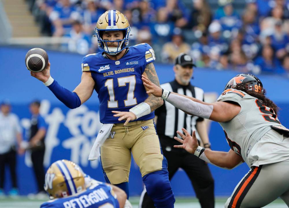 John Woods / THE CANADIAN PRESS
Winnipeg Blue Bombers quarterback Chris Streveler throws while under pressure from B.C. Lions’ Jonah Tavai (99) during the first half.