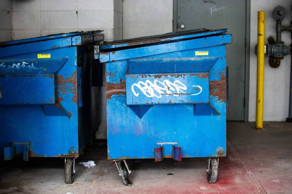 The dumpsters behind a Manitoba Housing building at 24 Carlton St., where a 27-year-old woman was assaulted and forcibly confined before being abandoned in a dumpster, while still restrained, in 2023. (Mikaela MacKenzie / Free Press files)