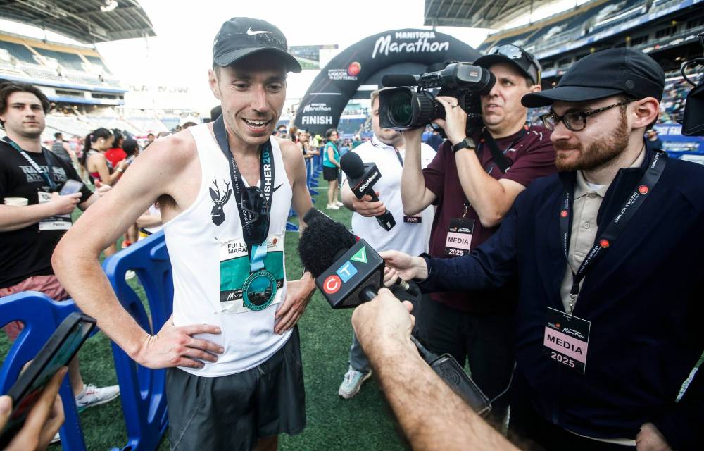 JOHN WOODS / FREE PRESS
Caleb de Jong speaks to reporters after crossing the finish line.