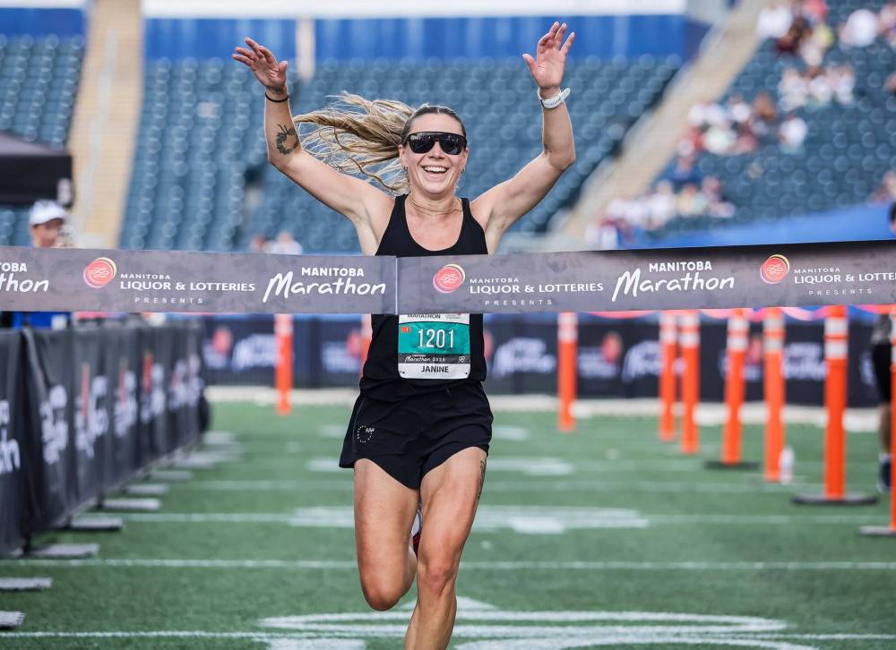 JOHN WOODS / FREE PRESS
Janine Zajac celebrates as she wins the Manitoba Marathon women's race.