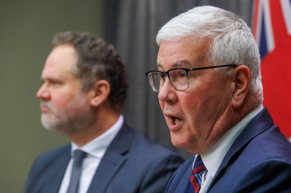 Garth Smorang (right), commissioner of the Winnipeg Police Service headquarters inquiry, with Justice Minister Matt Wiebe. (Mike Deal / Free Press files)