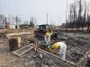 SUPPLIED
                                Members of Christian Aid Ministries Canada help clear debris from a property on Wendigo Road after wildfires recently ripped through the area.