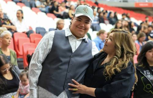 Ruth Bonneville / Free Press
                                Jonah Wavey, a grade 12 graduate from Tataskweyak Cree Nation, with his mom, Abbie Garson-Wavey, at the special graduation ceremony held by Winnipeg School Division in partnership with Assembly of Manitoba Chiefs, for graduates from northern Manitoba communities evacuated due to wildfires.