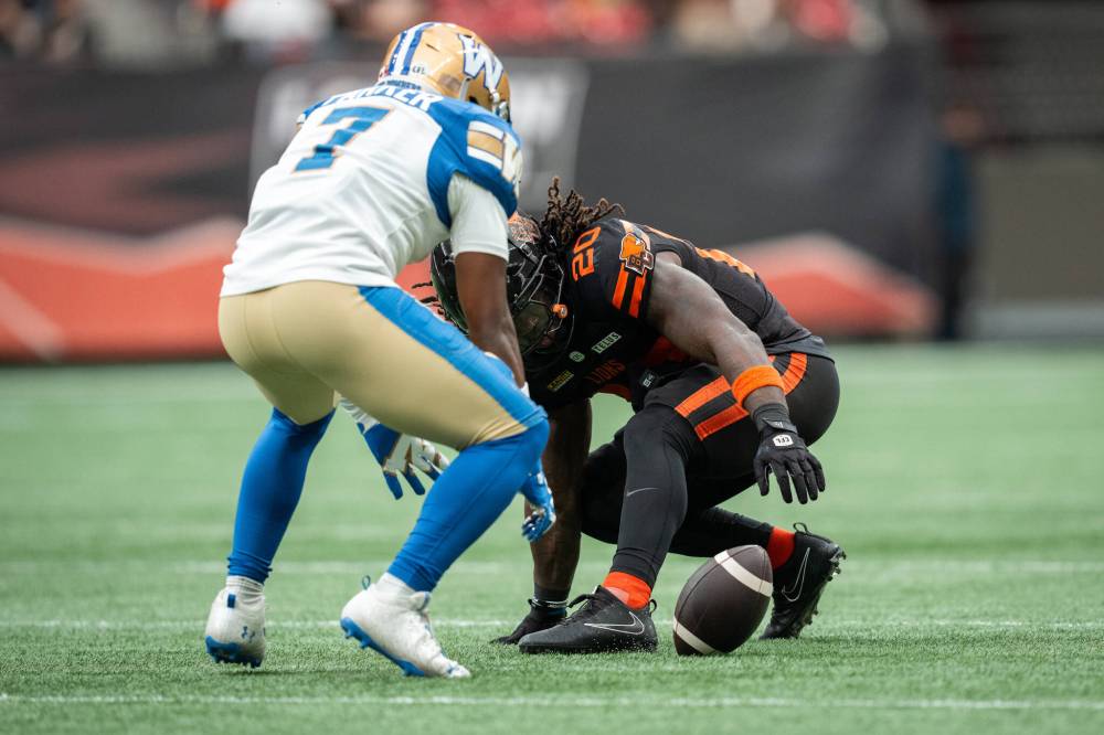 ETHAN CAIRNS / THE CANADIAN PRESS
B.C. Lions’ James Butler (20) fumbles the ball allowing Winnipeg Blue Bombers’ Jamal Parker (7) to score a touchdown during the first half of a CFL football game in Vancouver, on Saturday, June 21, 2025.