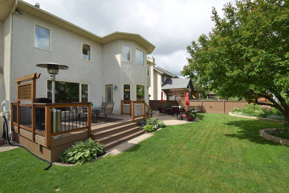 You won’t need a cottage with such a lovely backyard that has plenty of outdoor living space.