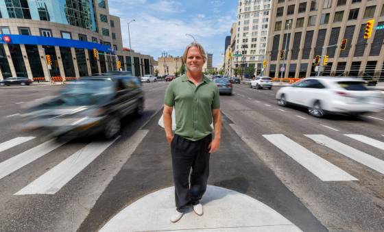 Brent Bellamy at Portage and Main the day before the crosswalks are going to become active, allowing people to cross the famous intersection, legally, for the first time since 1979. (Mike Deal / Free Press)