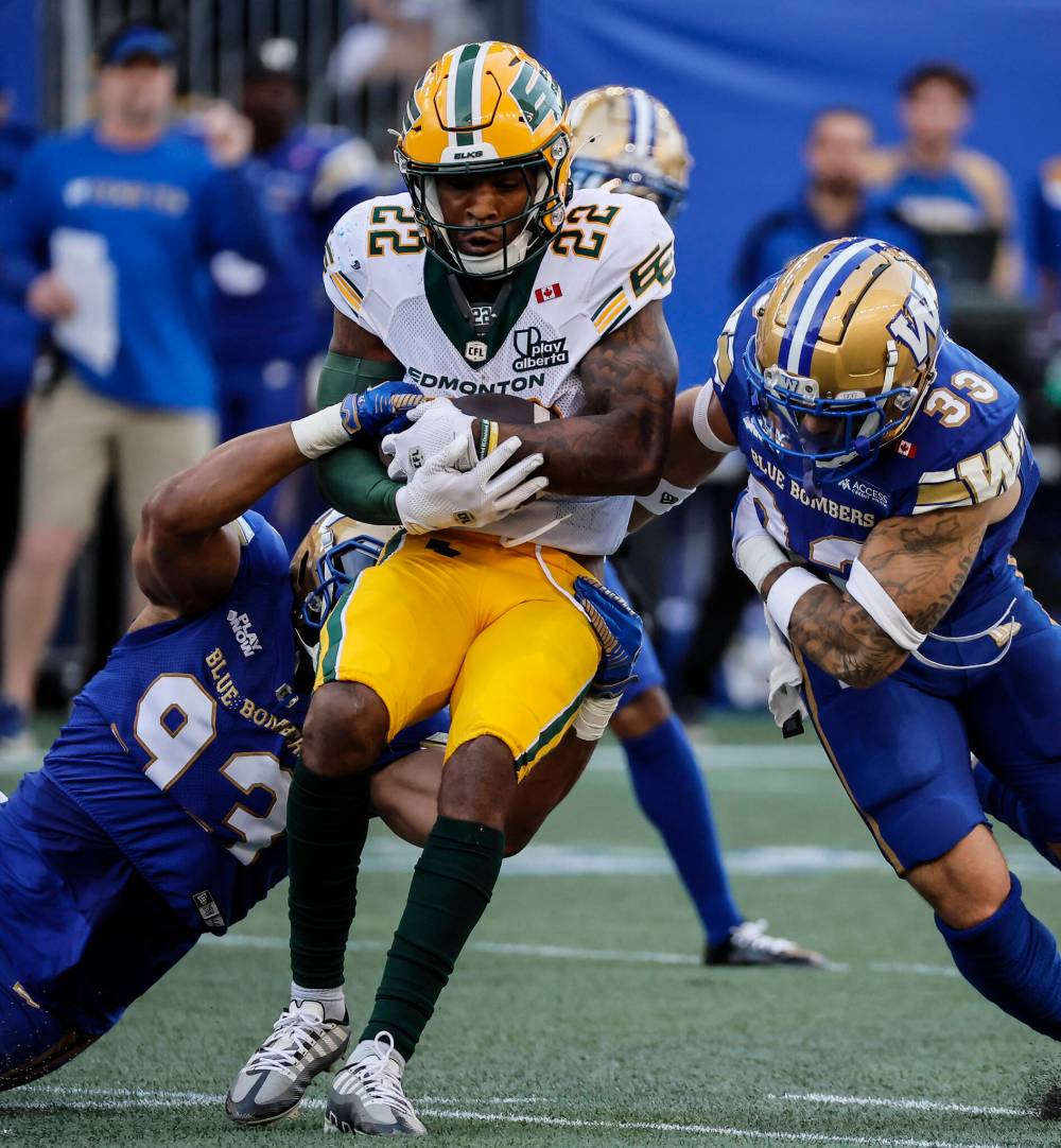 John Woods / THE CANADIAN PRESS
Edmonton Elks' Javon Leake runs for a first down in the first half against the Bombers, Thursday.