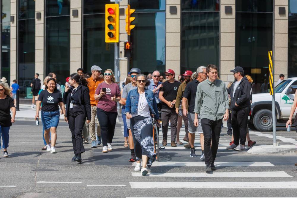 MIKE DEAL / FREE PRESS
Once crossing the street at Portage and Main became official, huge crowds of people made their way around to each of the crosswalks.