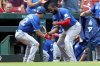 Toronto Blue Jays' Vladimir Guerrero Jr., right, and Ernie Clement celebrate after Clement's solo home run during the fifth inning of a baseball game against the St. Louis Cardinals, Wednesday, June 11, 2025, in St. Louis. (AP Photo/Scott Kane)
