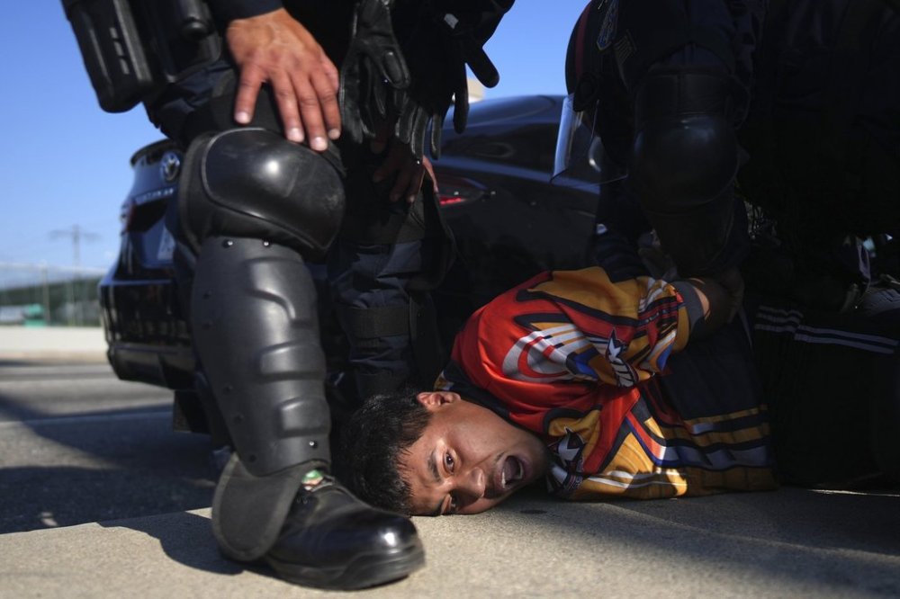 A protester is arrested by California Highway Patrol near the federal building in downtown Los Angeles on Tuesday, June 10, 2025. (AP Photo/Eric Thayer)