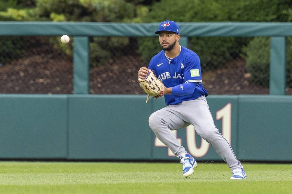 Toronto Blue Jays' Jonatan Clase runs down a single hut by Philadelphia Phillies' Weston Wilson during the eighth inning of a baseball game, Sunday, June 15, 2025, in Philadelphia. (AP Photo/Laurence Kesterson)
