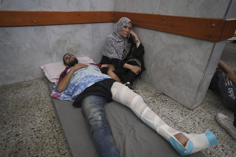 Mahmoud Al-Hosary is brought to Shifa Hospital in Gaza City after being injured on his way to an aid distribution center, Thursday, July 3, 2025. (AP Photo/Jehad Alshrafi)