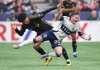 Vancouver Whitecaps' Tate Johnson, front, is upended by Los Angeles FC's David Martinez during the first half of an MLS soccer match, in Vancouver, on Sunday, May 11, 2025. THE CANADIAN PRESS/Darryl Dyck