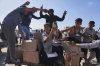 FILE - Palestinians carry boxes containing food and humanitarian aid packages delivered by the Gaza Humanitarian Foundation, a U.S.-backed organization approved by Israel, in Rafah, southern Gaza Strip, Tuesday, May 27, 2025. (AP Photo/Abdel Kareem Hana,File)
