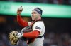 Patrick Bailey (14) walks back to the batter's box after a hit by Jose Iglesias (7) in the fifth inning as the San Francisco Giants played the San Diego Padres at Oracle Park in San Francisco, on Monday, June 2, 2025. (Carlos Avila Gonzalez/San Francisco Chronicle via AP)