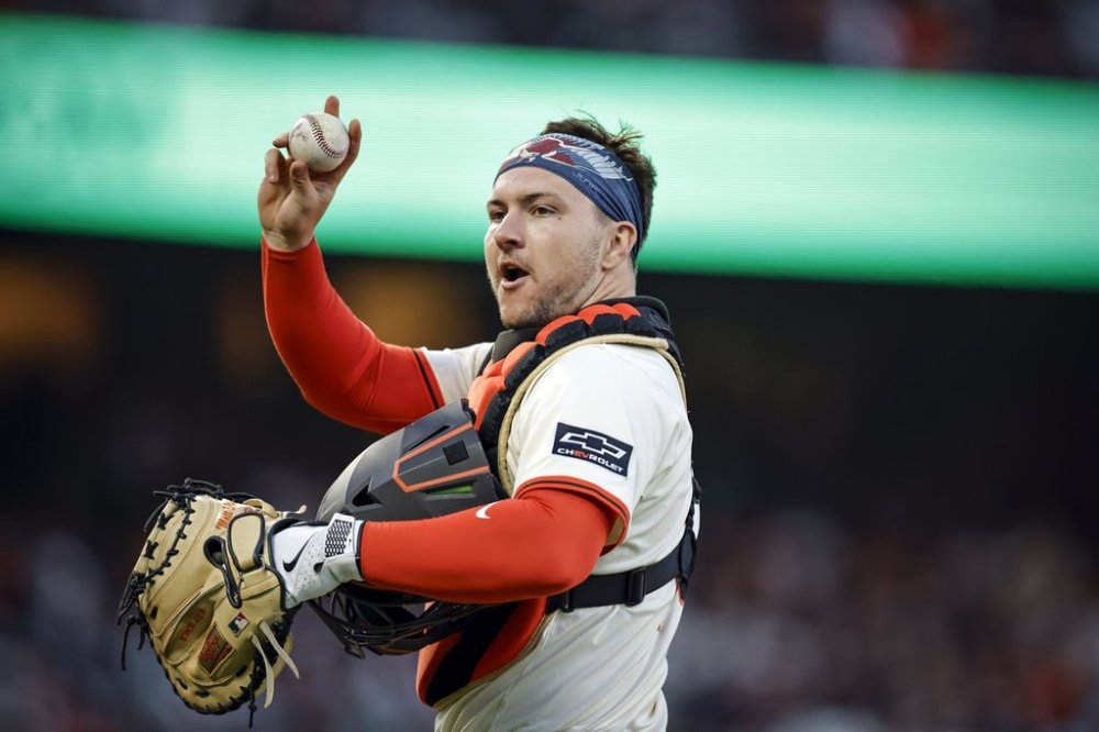 Patrick Bailey (14) walks back to the batter's box after a hit by Jose Iglesias (7) in the fifth inning as the San Francisco Giants played the San Diego Padres at Oracle Park in San Francisco, on Monday, June 2, 2025. (Carlos Avila Gonzalez/San Francisco Chronicle via AP)