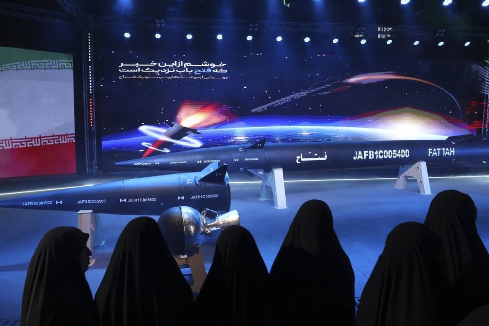 FILE - Women look at Fattah missile in a ceremony in Tehran, Iran, Tuesday, June 6, 2023. (Hossein Zohrevand/Tasnim News Agency via AP, File)