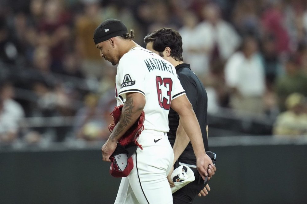 Arizona Diamondbacks pitcher Justin Martinez leaves the game due to injury during the ninth inning of a baseball game against the Seattle Mariners Monday, June 9, 2025, in Phoenix. (AP Photo/Ross D. Franklin)