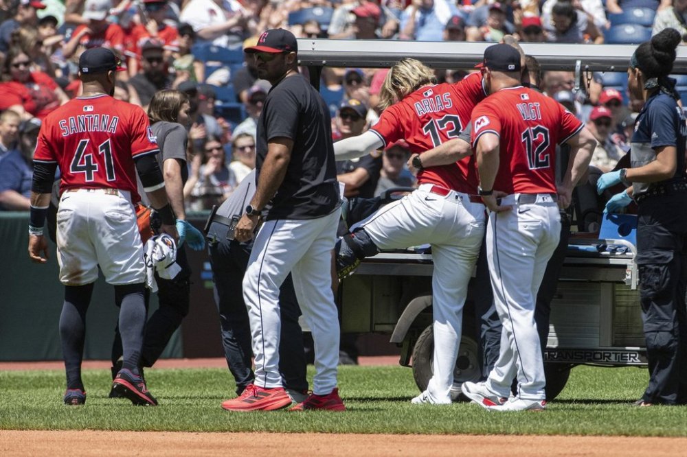 Cleveland Guardians' Gabriel Arias (13) is helped onto a medical cart after an injury as manager Stephan Vogt (12) and Carlos Santana (41) stand by during the third inning of a baseball game against the St. Louis Cardinals, Sunday, June 29, 2025, in Cleveland. (AP Photo/Phil Long)