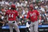 Cincinnati Reds' Tyler Stephenson (37)celebrates his grand slam with Elly De La Cruz (44) against the Detroit Tigers in the fifth inning during a baseball game, Saturday, June 14, 2025, in Detroit. (AP Photo/Paul Sancya)
