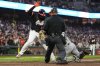 San Francisco Giants' Rafael Devers, left, is tagged out at home by Miami Marlins catcher Liam Hicks, right, during the fifth inning of a baseball game Tuesday, June 24, 2025, in San Francisco. (AP Photo/Godofredo A. Vásquez)