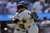New York Yankees pitcher Devin Williams, front, hugs catcher Austin Wells, back, after they defeated the New York Mets in a baseball game Sunday, July 6, 2025, in New York. (AP Photo/Adam Hunger)