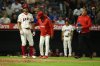 Los Angeles Angels' Chris Taylor reacts after being hit by a ball during the eighth inning of a baseball game against the Athletics, Monday, June 9, 2025, in Anaheim, Calif. (AP Photo/William Liang)
