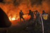 Emergency responders with the Syrian Civil Defense, known as the White Helmets, work to extinguish a wildfire near the town of Rabia, in Syria's Latakia countryside, early Monday, July 7, 2025. (AP Photo/Ghaith Alsayed)