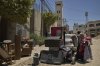 Palestinians gather their belongings ahead of homes demolition by Israeli forces in the Tulkarem refugee camp, West Bank, Wednesday, July 2, 2025. (AP Photo/Leo Correa)