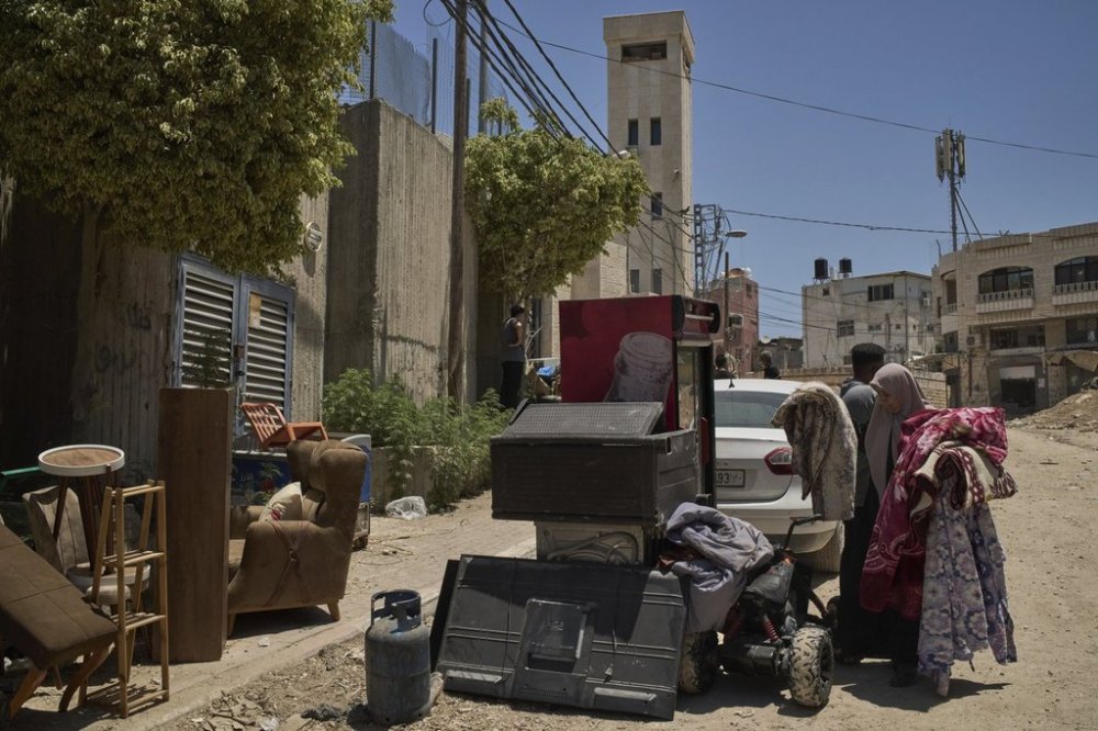 Palestinians gather their belongings ahead of homes demolition by Israeli forces in the Tulkarem refugee camp, West Bank, Wednesday, July 2, 2025. (AP Photo/Leo Correa)