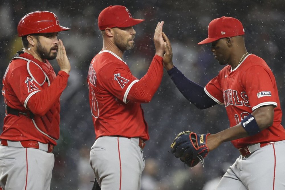 Los Angeles Angels' Travis d'Arnaud, left, Hunter Strickland, center, and Jorge Soler, right, react after defeating the New York Yankees in a baseball game Monday, June 16, 2025, in New York. (AP Photo/Pamela Smith)