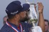 J.J. Spaun celebrates with the trophy after winning the U.S. Open golf tournament at Oakmont Country Club Sunday, June 15, 2025, in Oakmont, Pa. (AP Photo/Carolyn Kaster)