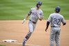 Texas Rangers' Evan Carter, left, rounds the bases on his two-run home run next to third base coach Tony Beasley (27) during the second inning of a baseball game against the Washington Nationals, Sunday, June 8, 2025, in Washington. (AP Photo/Nick Wass)