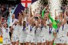 FILE - England's Leah Williamson, center left, and Millie Bright lift the trophy after winning the Women's Euro 2022 final soccer match between England and Germany at Wembley stadium in London, July 31, 2022. England won 2-1. (AP Photo/Alessandra Tarantino, File)