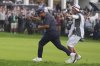 J.J. Spaun celebrates with his caddie, Mark Carens, after making a birdie putt on the 18th hole during the final round of the U.S. Open golf tournament at Oakmont Country Club Sunday, June 15, 2025, in Oakmont, Pa. (AP Photo/Seth Wenig)