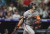 San Francisco Giants' Mike Yastrzemski follows the flight of his double to drive in two runs off Colorado Rockies relief pitcher Tyler Kinley in the eighth inning of a baseball game Wednesday, June 11, 2025, in Denver. (AP Photo/David Zalubowski)