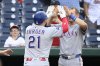 Texas Rangers' Jake Burger celebrates his home run with Josh Jung during the eighth inning of a baseball game against the Washington Nationals, Sunday, June 8, 2025, in Washington. (AP Photo/Nick Wass)