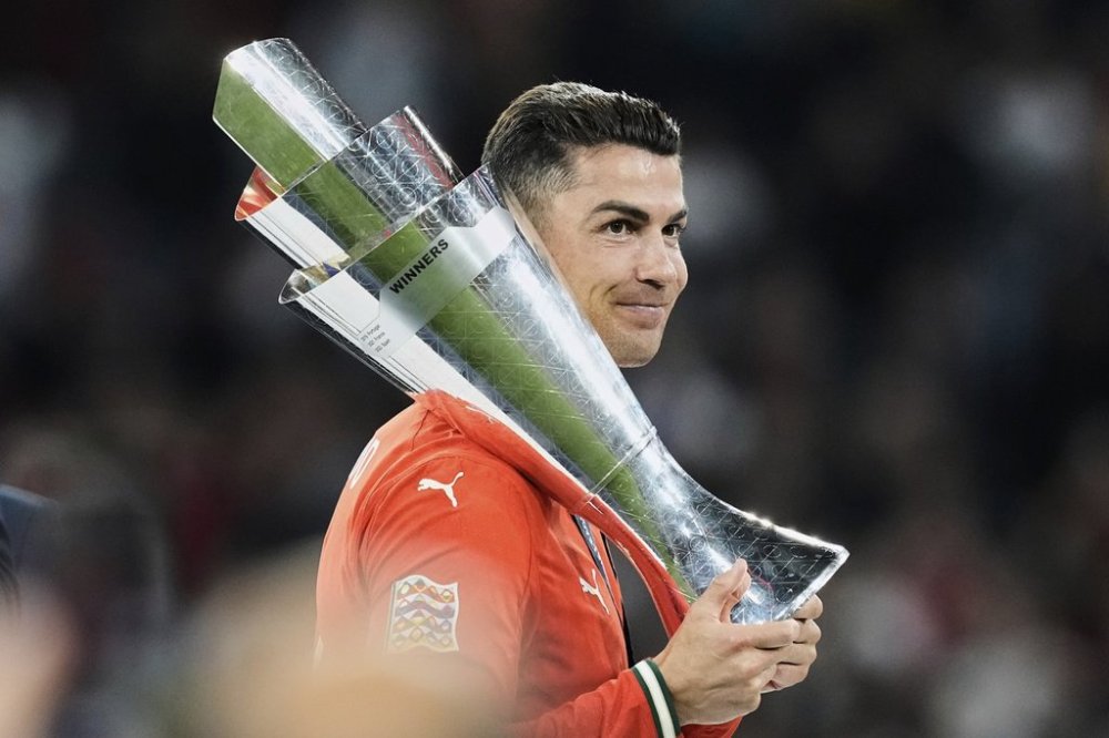 Portugal's Cristiano Ronaldo holds the trophy after winning the Nations League soccer championship at the Allianz Arena in Munich, Germany, Sunday, June 8, 2025. (AP Photo/Martin Meissner)