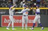 From left, Los Angeles Dodgers left fielder Kike Hernández, center fielder Andy Pages and right fielder Teoscar Hernández celebrate after defeating the Colorado Rockies in a baseball game Tuesday, June 24, 2025, in Denver. (AP Photo/David Zalubowski)