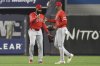 Los Angeles Angels' Jo Adell, left, and Jorge Soler, right, react after defeating the New York Yankees during a baseball game Tuesday, June 17, 2025, in New York. (AP Photo/Pamela Smith)