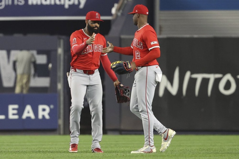 Los Angeles Angels' Jo Adell, left, and Jorge Soler, right, react after defeating the New York Yankees during a baseball game Tuesday, June 17, 2025, in New York. (AP Photo/Pamela Smith)