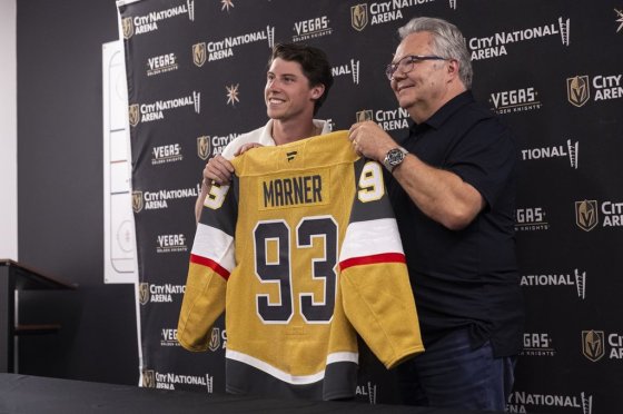 Mitch Marner, left, poses for a photo with his jersey alongside Golden Knights general manager Kelly McCrimmon in July 2025. (Chase Stevens/Las Vegas Review-Journal via The Associated Press files)
