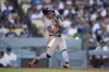 Houston Astros' Jose Altuve hits a two-run home run during the third inning of a baseball game against the Los Angeles Dodgers in Los Angeles, Friday, July 4, 2025. (AP Photo/Kyusung Gong)