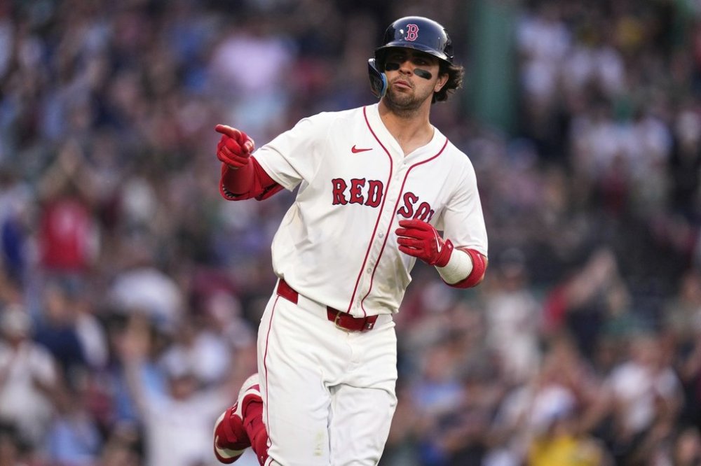 Boston Red Sox's Marcelo Mayer points towards the Red Sox dugout while rounding the bases on his solo home run during the second inning of a baseball game against the Tampa Bay Rays at Fenway Park, Wednesday, June 11, 2025, in Boston. (AP Photo/Charles Krupa)