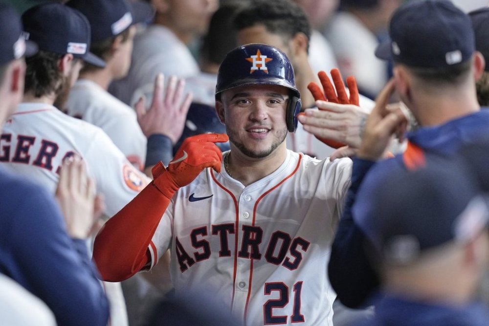 IHouston Astros' Yainer Diaz (21) celebrates in the dugout after hitting a two-run home run against the Minnesota Twins during the third inning of a baseball game Saturday, June 14, 2025, in Houston. (AP Photo/David J. Phillip)