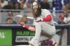 Philadelphia Phillies' Brandon Marsh reacts after hitting a triple during the seventh inning of a baseball game against the Miami Marlins, Monday, June 16, 2025, in Miami. (AP Photo/Lynne Sladky)